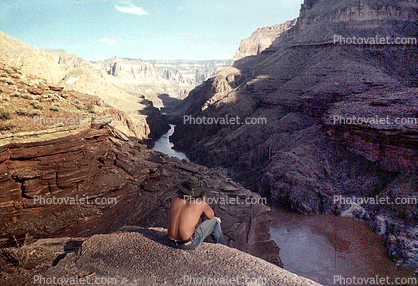 Man sitting over a cliff, Colorado River