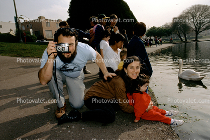 Camera, photographer, smiling lady, child, pond, swan
