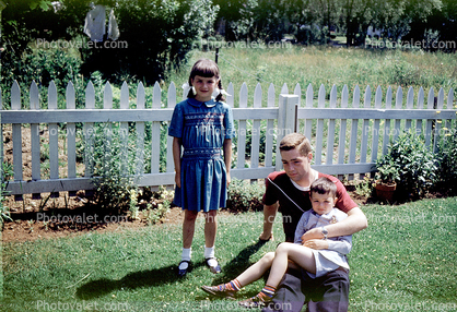 backyard, girl, boy, picket fence, 1950s