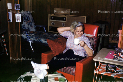 Woman, Recliner Chair, female, drinking tea, socks, pants, living room, 1950s