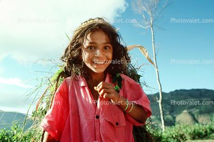 Girl carrying vegetation, deforestation, desertification