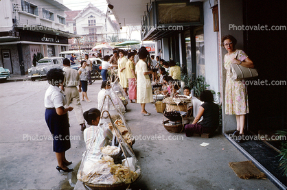 street market, sellers, vendors, shoppers, sidewalk, cars, Bangkok, Thailand, October 1962, 1960s