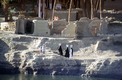 Women walking with pails of water, Nile River, Luxor