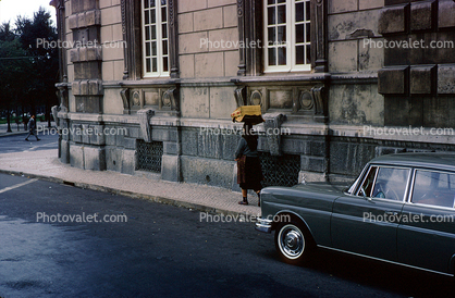 Woman walking, sidewalk, car, building, Lisbon Portugal, October 1966