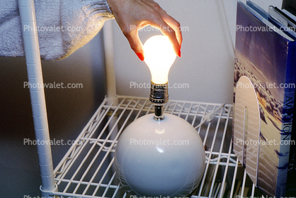 Changing a light bulb, Womans Hand, fingernails, hazard