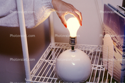 Changing a light bulb, Womans Hand, fingernails, hazard