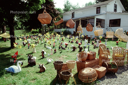 frontyard full of figurines, elfs, cats, mother goose, front yard, hammock, home, house, baskets