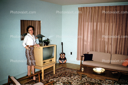 Television, TV, Woman, couch, curtains, guitar, coffee table, dress, bullet bra, 1960s