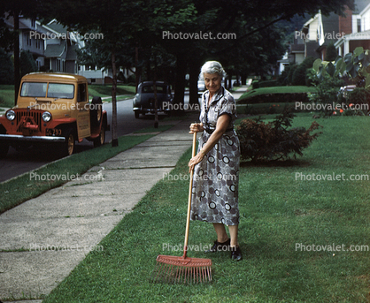 Grandma Racking Leaves, frontyard, 1950s