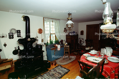 Stove, table, plates, rugs, wooden stove, kerosene lamps