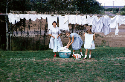 Mother and Daughters hanging laundry to dry, 1950s