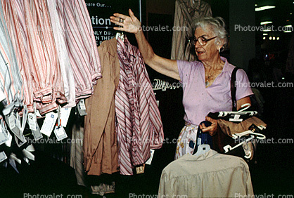 Woman Shopping at a Store, Mall, shoppers, clothing store, woman, racks, 1980s