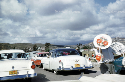 Mexican Side of The Border crossing, Vendors Selling their Wares, Cadillac Car, Ford Custom, 1950s