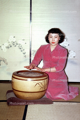 Geisha Girl warming her hands, Prostitute, Hooker, drums, drumming, Japanese Brothel, Sasebo Saga Japan, 1950s