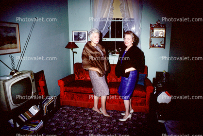Women in fur shawls, sofa, television, 1966, 1960s