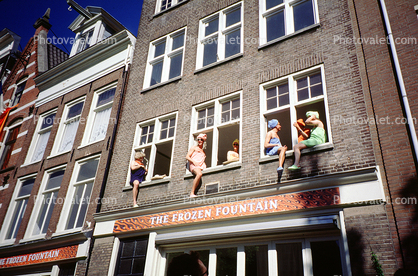 People sitting in Window Sills watching a parade, crossdressers 