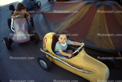 Kiddie ride, racing cars, girl, cute, 1950s