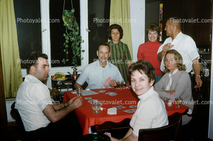 Family playing cards, card table, girls, women, men, 1950s