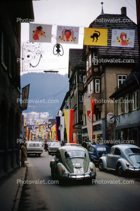 Volkswagen, cars, street, buildings, Parade, Fasnet, Carnival, flags, banners, Schramberg, Baden-Wurttemberg, Black Forest, Germany, spectators