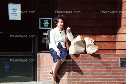 Woman Sitting on a Brick Wall