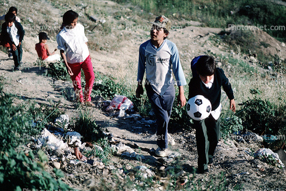 Boys, walking, soccer ball, trash, Colonia Flores Magone