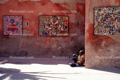 Wall with artwork, man sitting