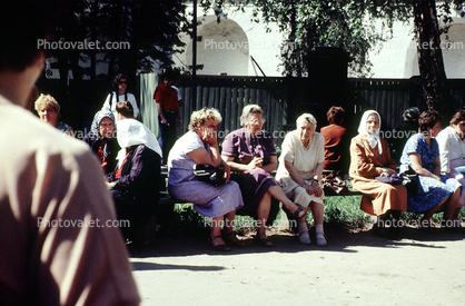 Women sitting on a bench, summertime