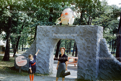 Humpty Dumpty, girl, woman, dress, purse, gate, wall, storybook, September 1959, 1950s