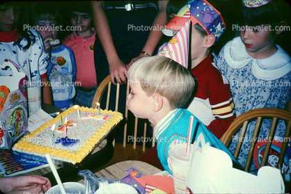 Boy Blowing out a Birthday Cake, candles, girl, cap, making a wish