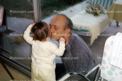 dad and child, kiss, love, glass door, May 1966, 1960s
