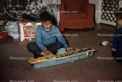 Boy with his Aircraft Carrier Christmas Toy, 1950s