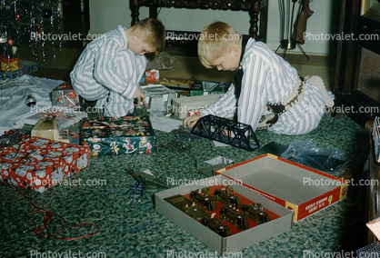 Boys playing with their new Christmas toys, army, presents, pajamas, 1950s