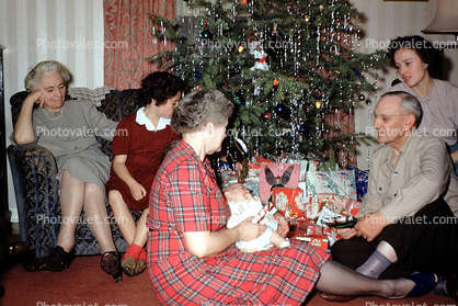 Opening Presents, Gifts, tinsel, baby, grandma, grandmother, mother,  1950s, 1950s