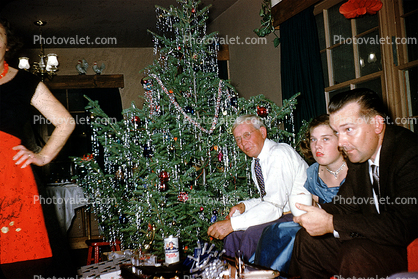 Tree, tinsel, man, woman, suit and tie, 1960s