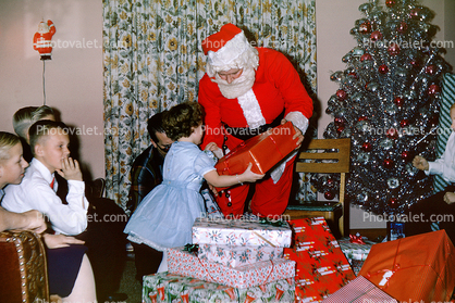 Santa Claus handing a present to a Girl, Boys, 1950s