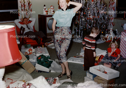 Woman Shows off her New Outfit, pants, decorated Tree, 1950s