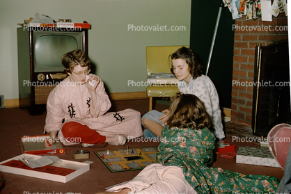 Presents, Television, girls playing a board game, pajama, 1950s