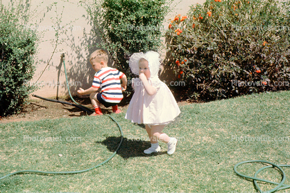 Girl with Bonnet, Backyard, Hose, Boy, Lawn, April 1965, 1960s