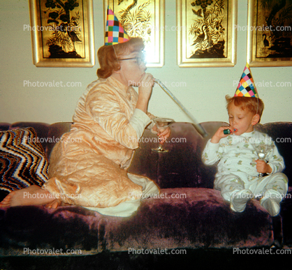 Mother, Son, Sofa, Couch, jammies, birthday hats, 1950s, Mom and Son partying, noisemaker, Robe, Pajama, party hat, cap, nightwear