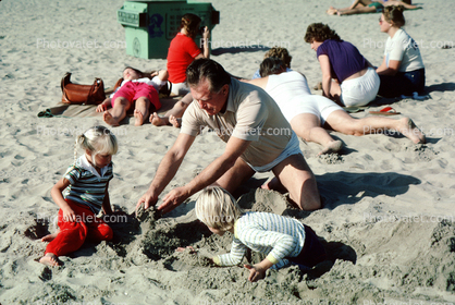 Grandpa Playing in the sand with grandaughters, Laguna Beach