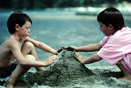 boys building a sandcastle