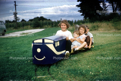 backyard train, Girls, Boys, Smiles, Miniature Train, Riding, smiling, cute, flat car, Akron Ohio, 1950s
