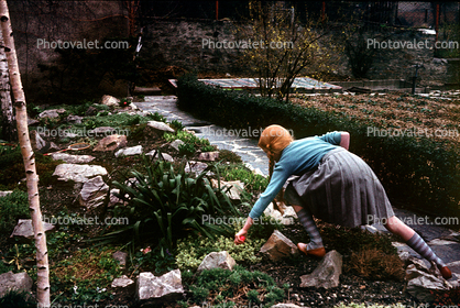 Schoolgirl Skirt, redhead, stream, backyard, stepping stones, 1950s