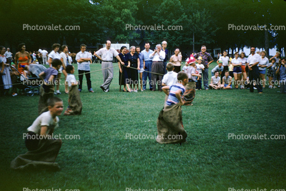 Sock Hop race, burlap sacks, competition, bystanders, boys, 1940s