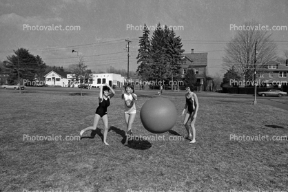 Teen Girls playing wit a big rubber ball, 1960s
