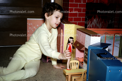Girl Playing House with her Barbie Doll, pajama, December 25 1964