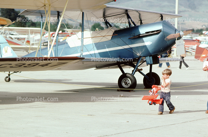 Boy with Red Baron Biplane Toy