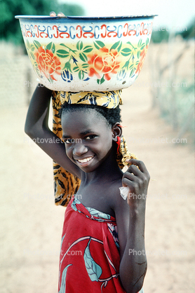 Smiling Girl Carrying a Big Bowl
