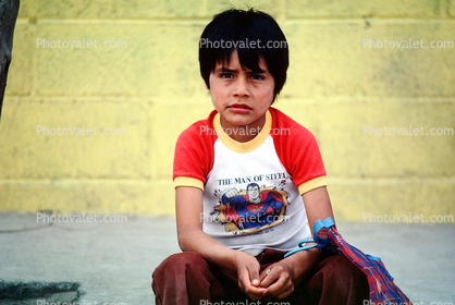 Boy Sitting on a sidewalk, Colonia Flores Magone