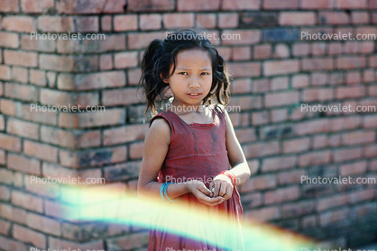 Girl, brick wall